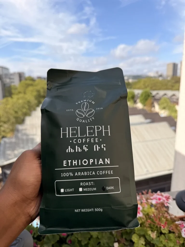 Heleph Ethiopian coffee bag held up against a blue sky
