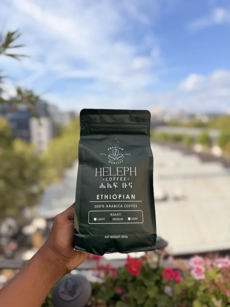 Heleph coffee bag held up on a rooftop with city view