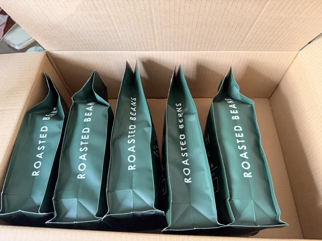 Five Heleph roasted beans bags lined up in a shipping box