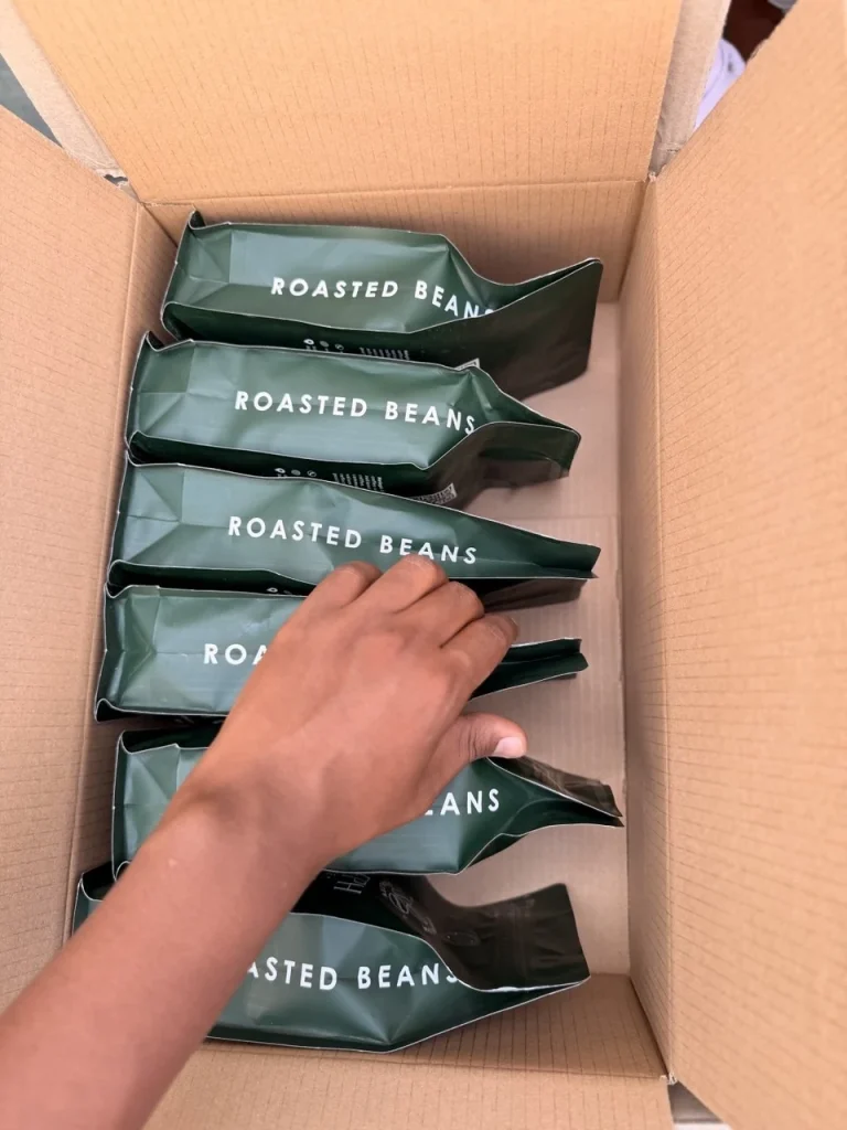 Packing Heleph roasted coffee bags into a carton