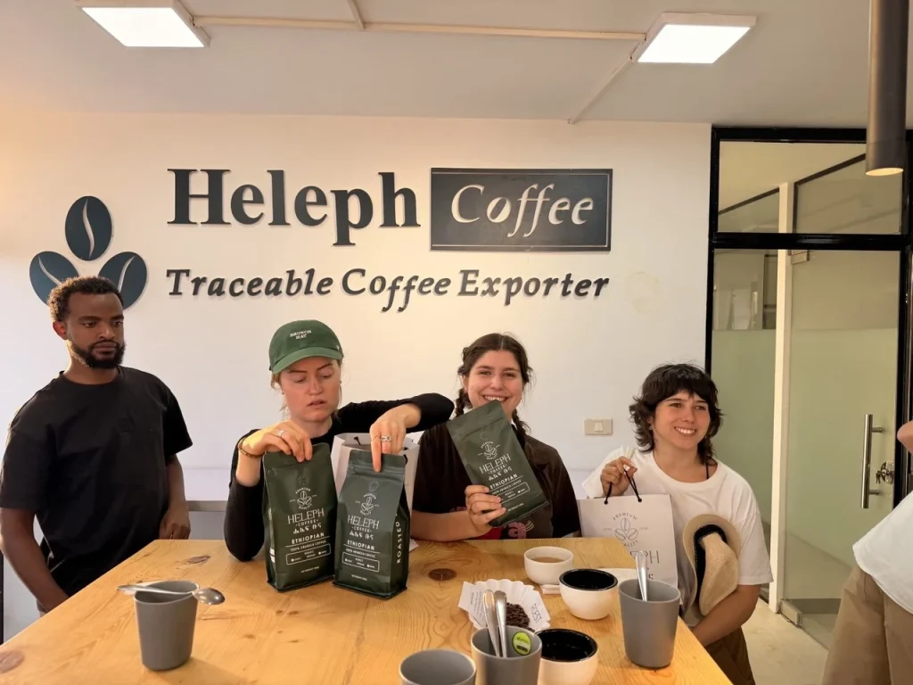 Visitors holding Heleph coffee at the Traceable Coffee Exporter tasting room