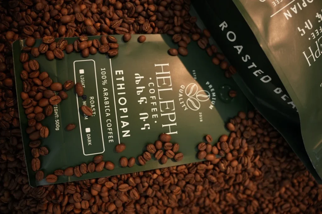 Heleph Ethiopian coffee bag surrounded by roasted beans