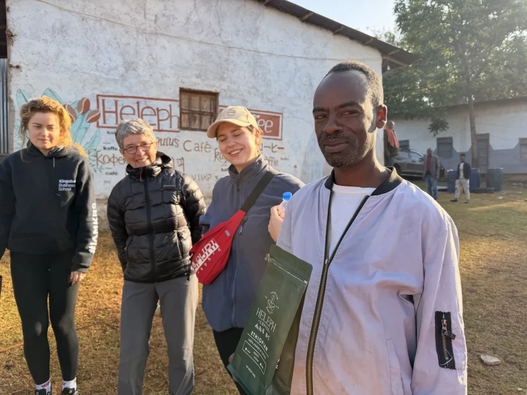 Coffee farmer with international visitors at the Heleph washing station