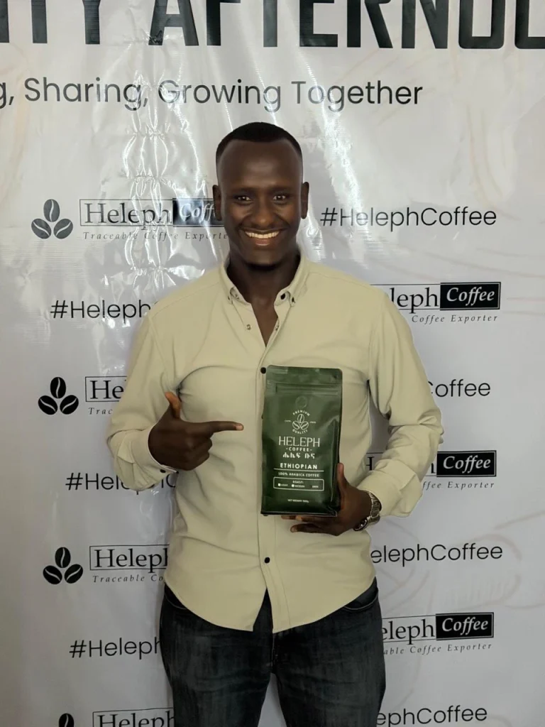 Guest holding Heleph coffee at the Community Afternoon event